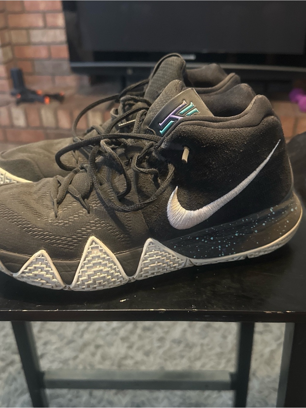 Nike Kyrie Black High-Top Basketball Shoes with White Swoosh and Teal Accent